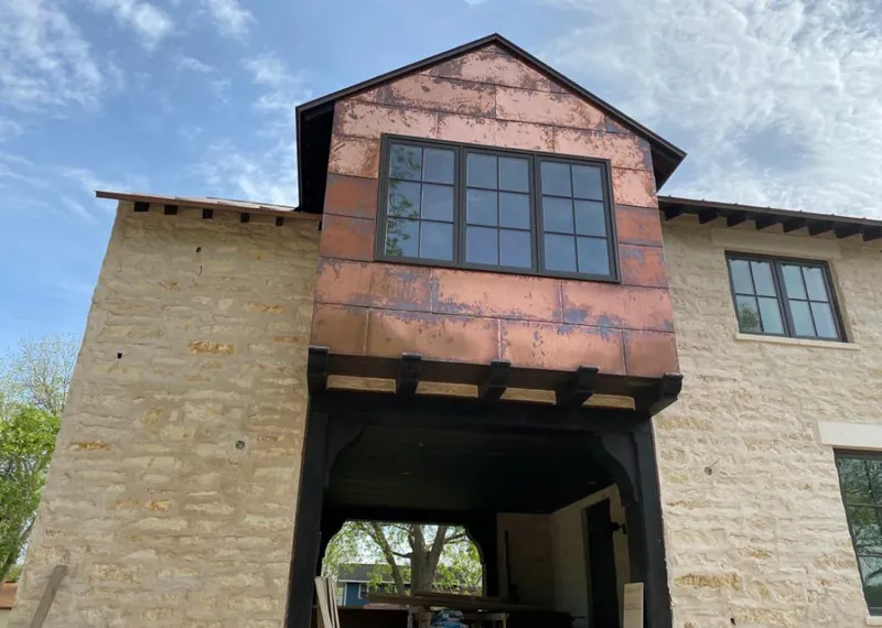 Copper metal panel facade on a stone building for Skylight Installation in Hoover